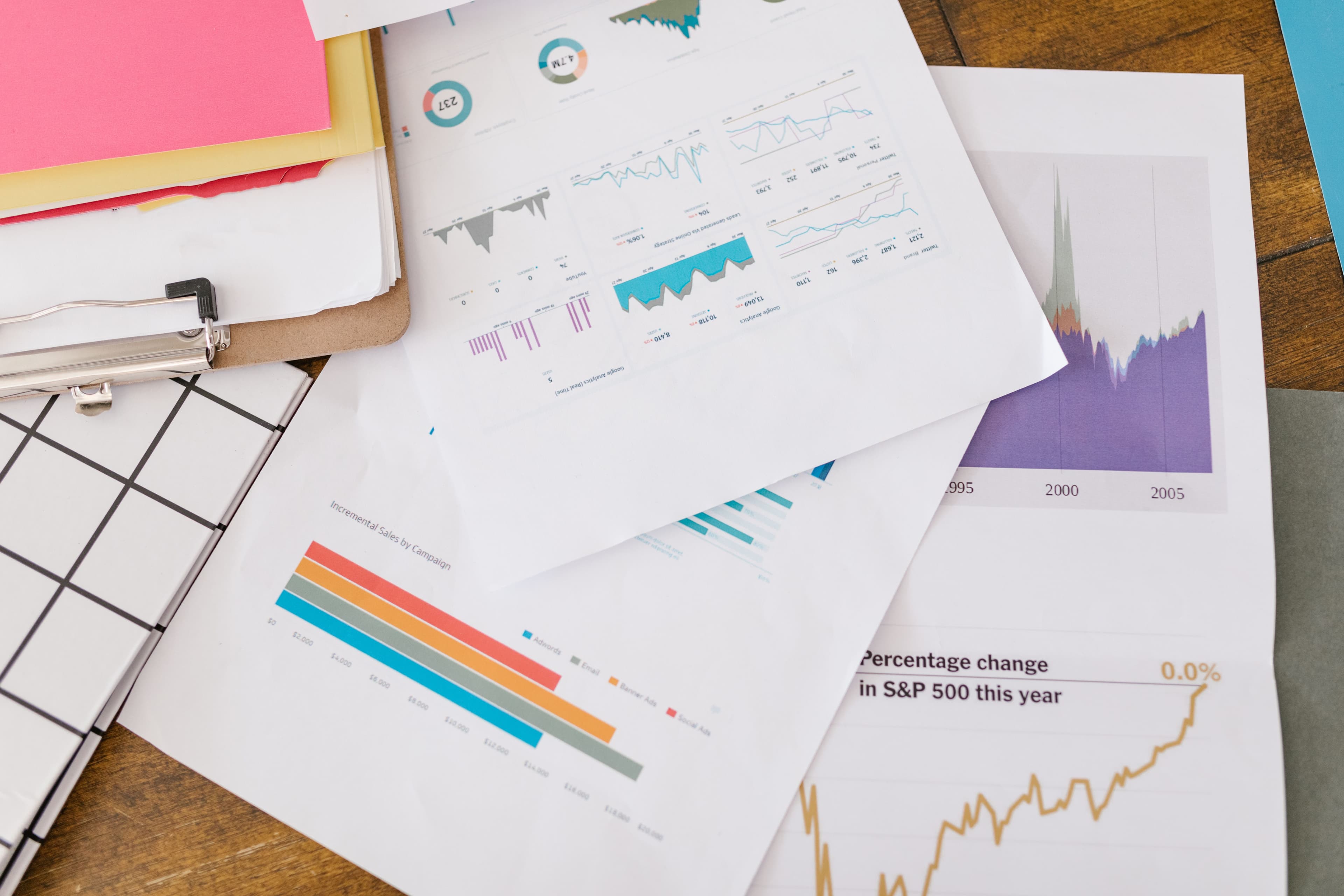 Printed charts and reports spread across a desk